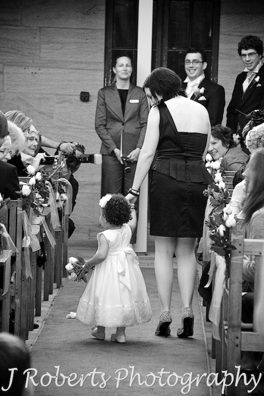 Flower girl walking down the aisle holding Mum's hand - wedding photography sydney
